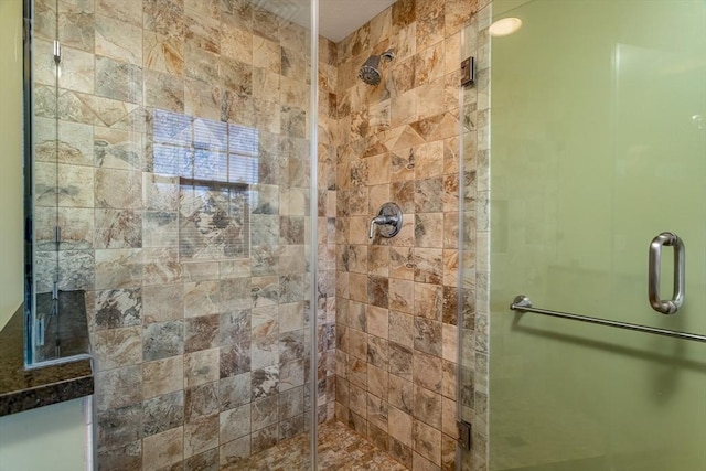 bathroom with a shower with door