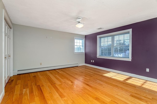 unfurnished bedroom with ceiling fan, light hardwood / wood-style flooring, and a baseboard radiator