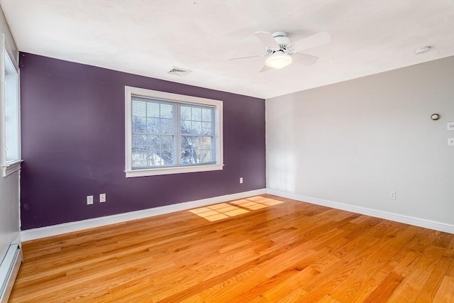 spare room with ceiling fan and light wood-type flooring