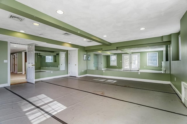 unfurnished room featuring french doors