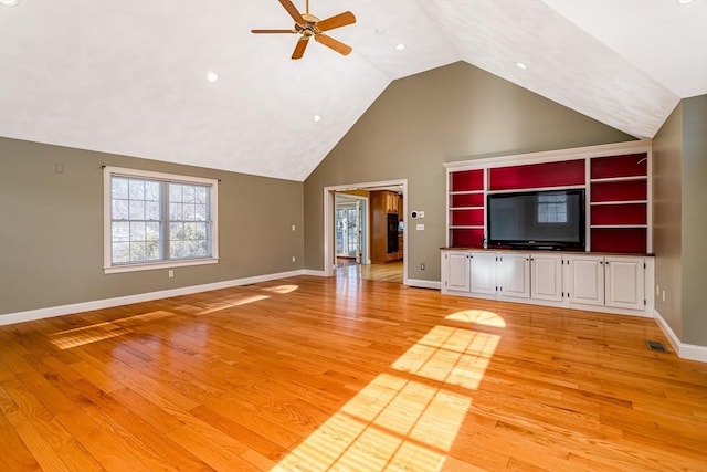 unfurnished living room featuring hardwood / wood-style floors, ceiling fan, and lofted ceiling