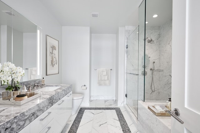 bathroom with vanity, a shower with shower door, and toilet