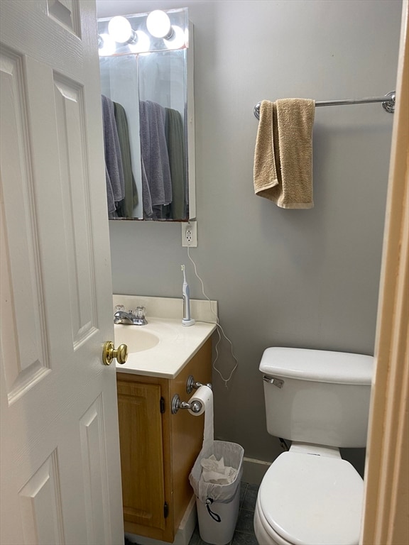 bathroom featuring toilet and vanity