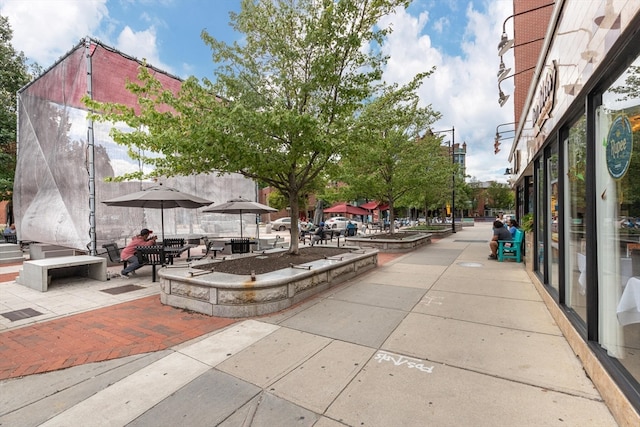 surrounding community featuring an outdoor living space and a patio