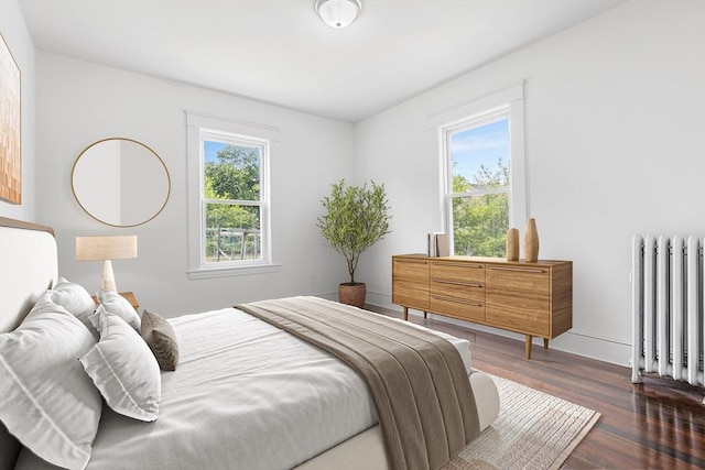 75 Norcross St, Lowell, MA 01851 - bedroom with radiator, wood finished floors, and baseboards