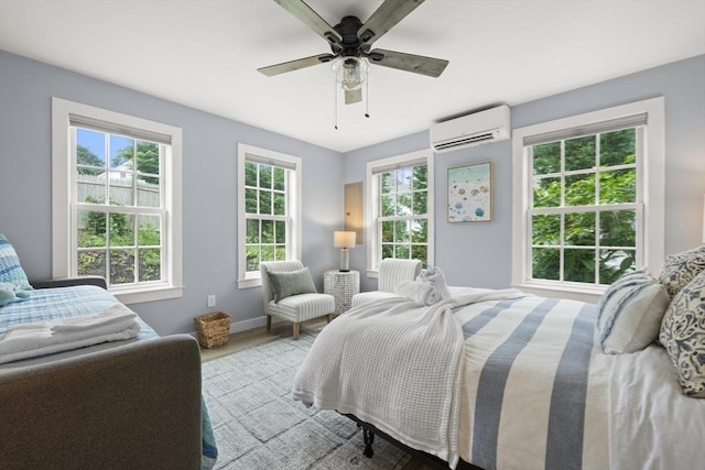 bedroom with multiple windows, a wall mounted AC, and ceiling fan