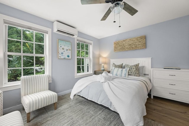 bedroom with ceiling fan, dark hardwood / wood-style floors, and a wall mounted air conditioner