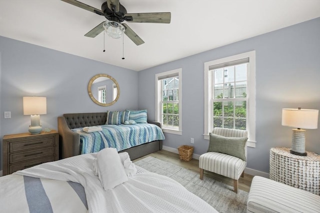 bedroom with light wood-type flooring and ceiling fan