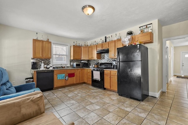 kitchen with light tile patterned floors, decorative backsplash, under cabinet range hood, black appliances, and a sink