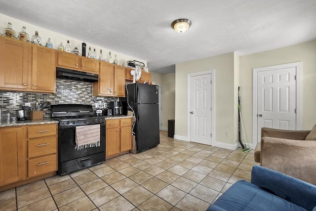 kitchen featuring tasteful backsplash, under cabinet range hood, black appliances, and light tile patterned floors