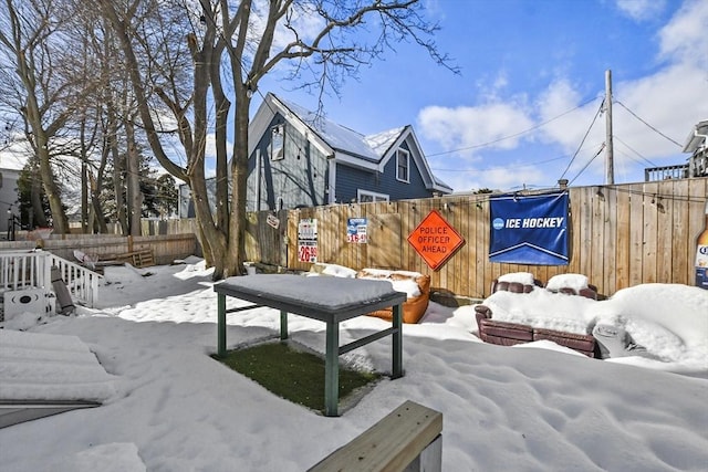 snowy yard with fence