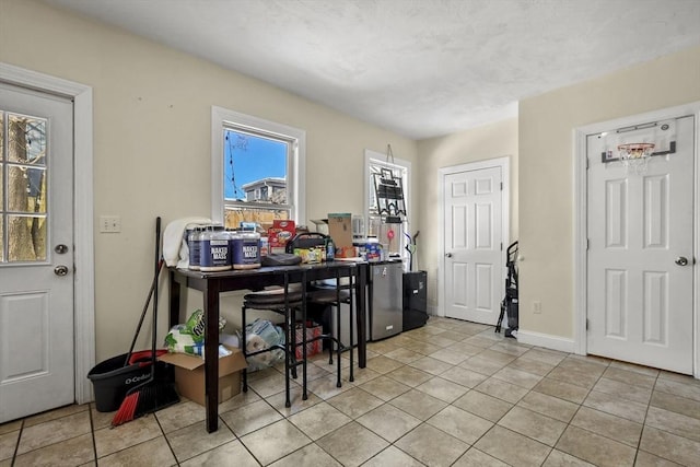 dining room with light tile patterned floors and baseboards