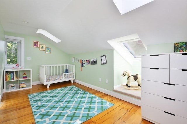 4 Perry St Unit 2, Brookline, MA 02445 - bedroom featuring a skylight, lofted ceiling, and hardwood / wood-style floors