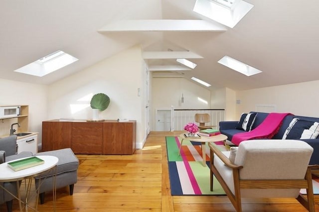 4 Perry St Unit 2, Brookline, MA 02445 - living area with a skylight, vaulted ceiling, and light wood-style floors