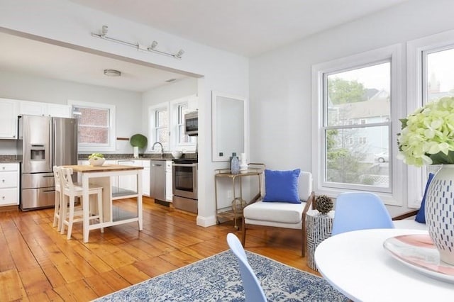 4 Perry St Unit 2, Brookline, MA 02445 - kitchen featuring appliances with stainless steel finishes, white cabinetry, and light wood finished floors