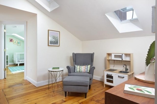 4 Perry St Unit 2, Brookline, MA 02445 - living area featuring a skylight, lofted ceiling, and light wood finished floors