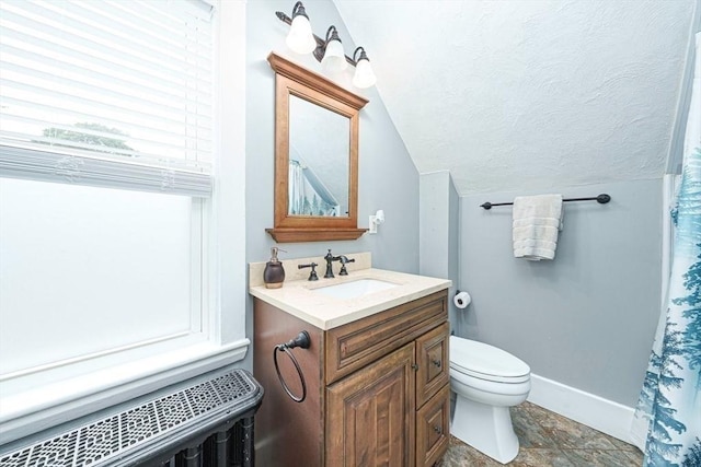 67 Pine St, Milford, MA 01757 - bathroom featuring lofted ceiling, vanity, toilet, baseboards, and radiator