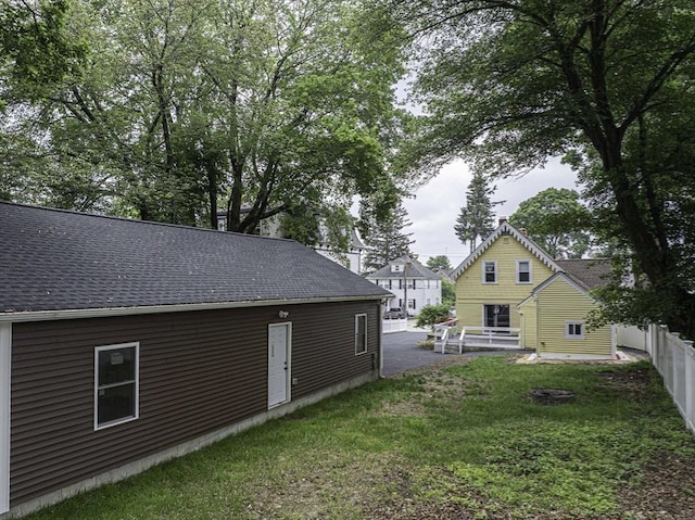 67 Pine St, Milford, MA 01757 - back of property with a patio and roof with shingles