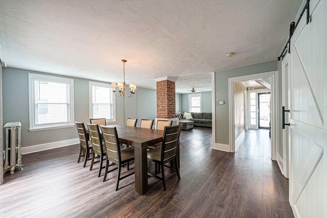 67 Pine St, Milford, MA 01757 - dining room with dark wood-style floors, a barn door, baseboards, a textured ceiling, and healthy amount of natural light