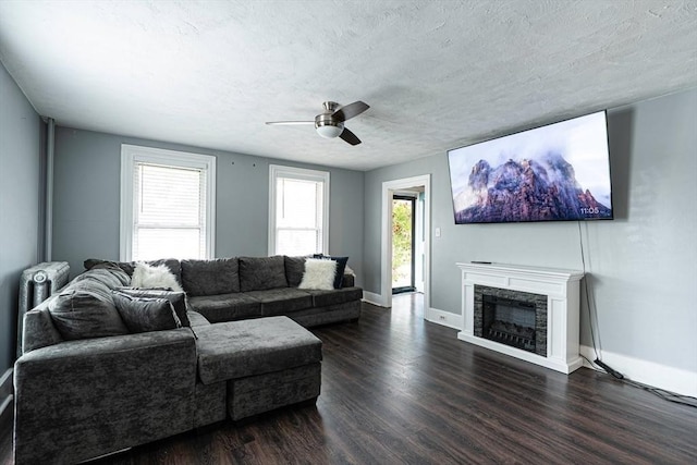 67 Pine St, Milford, MA 01757 - living area featuring ceiling fan, dark wood-style floors, a fireplace, baseboards, and a textured ceiling