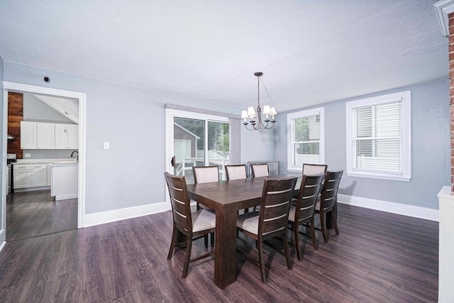 67 Pine St, Milford, MA 01757 - dining area with a chandelier, dark wood-type flooring, and baseboards