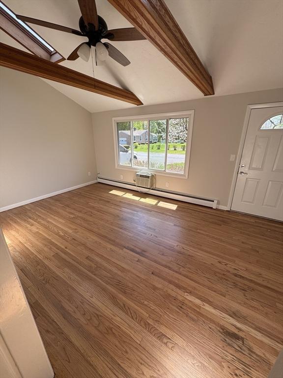 entrance foyer featuring baseboards, wood finished floors, a ceiling fan, and vaulted ceiling with beams