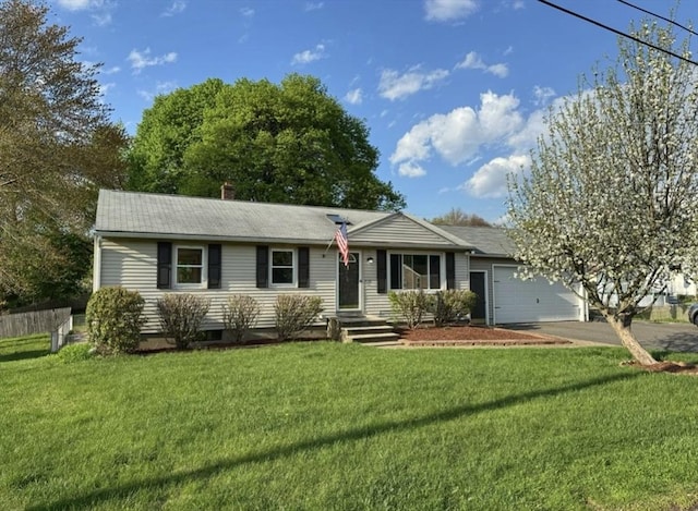 ranch-style home with a front lawn, driveway, a chimney, and an attached garage