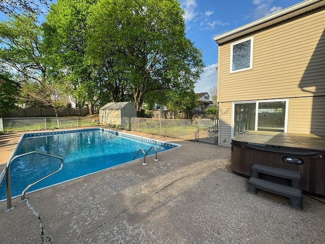 view of swimming pool with a patio, a gate, a hot tub, a fenced backyard, and a fenced in pool