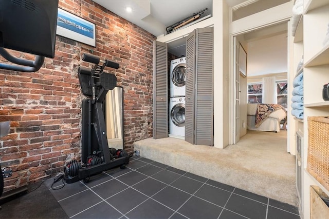 interior space featuring stacked washer and clothes dryer