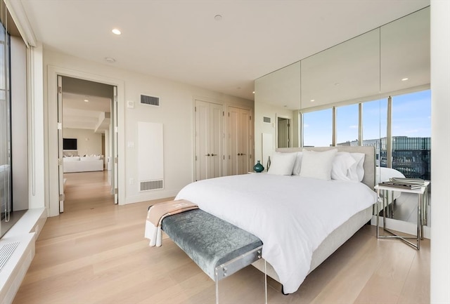 bedroom with recessed lighting, visible vents, and light wood finished floors