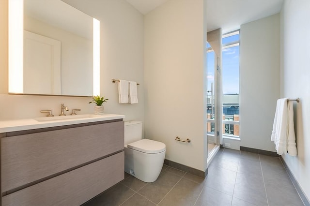 full bath with tile patterned flooring, a shower, vanity, baseboards, and toilet