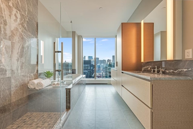 bathroom with vanity, tile patterned floors, a shower stall, a city view, and backsplash