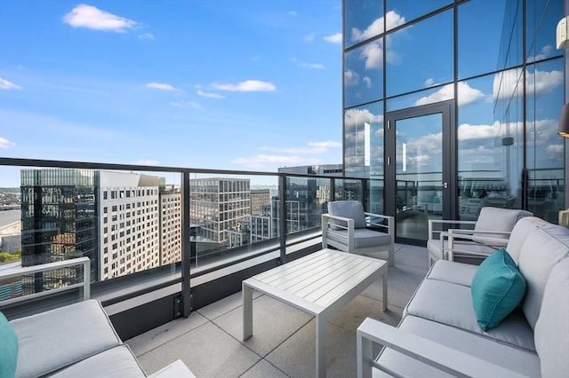 balcony featuring an outdoor hangout area and a view of city
