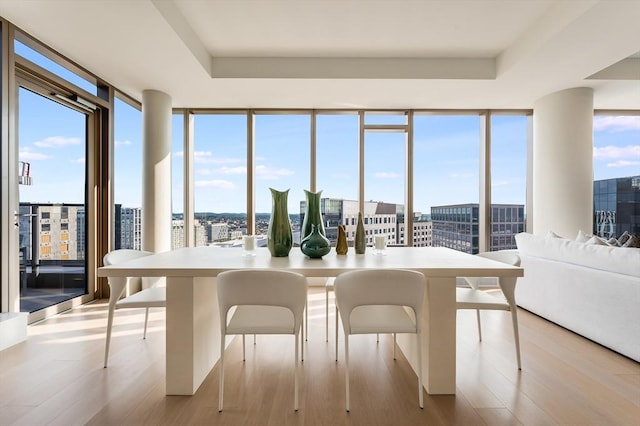 sunroom / solarium featuring a view of city and a wealth of natural light