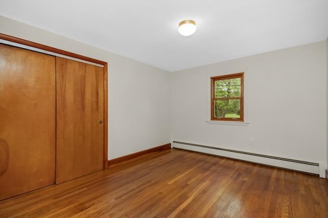 19 Chase St, Taunton, MA 02780 - unfurnished bedroom with baseboard heating, wood finished floors, and a closet