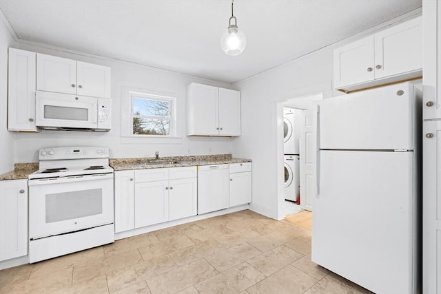 kitchen featuring stacked washer and clothes dryer, sink, white cabinetry, pendant lighting, and white appliances