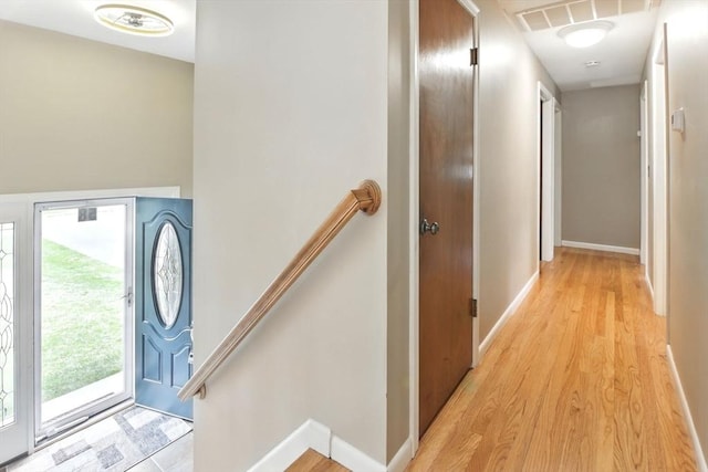 foyer entrance with visible vents, baseboards, and light wood-style floors