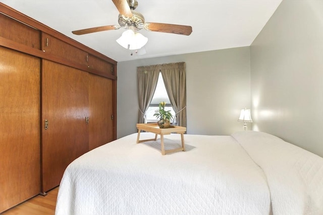 bedroom featuring a closet, ceiling fan, and light wood-type flooring