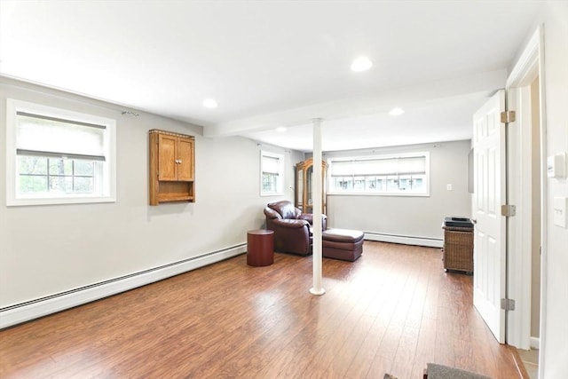 sitting room with baseboard heating, recessed lighting, and wood finished floors