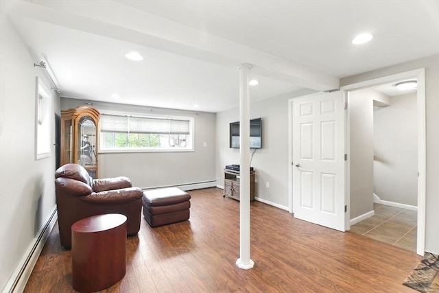living area featuring recessed lighting, wood finished floors, and a baseboard heating unit