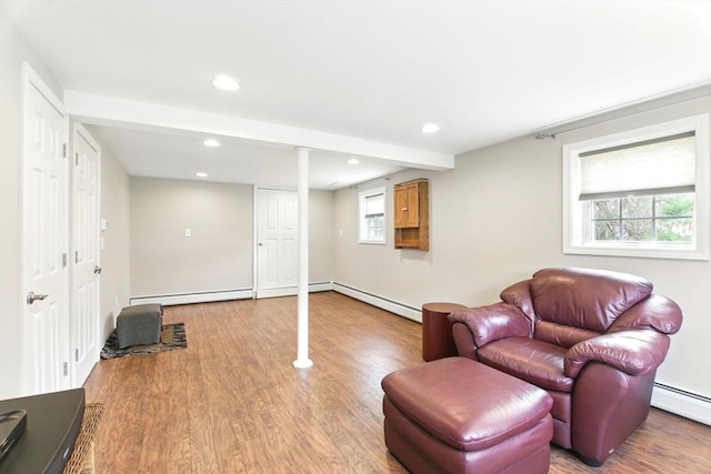 sitting room with recessed lighting, wood finished floors, and a baseboard heating unit