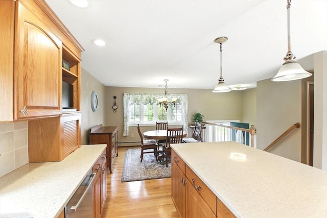 kitchen with pendant lighting, tasteful backsplash, stainless steel dishwasher, a chandelier, and light wood finished floors