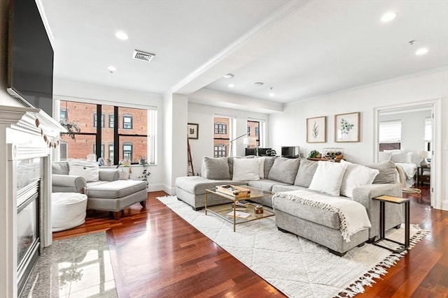 living room featuring ornamental molding, a high end fireplace, and hardwood / wood-style floors