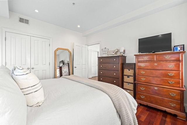 bedroom featuring dark hardwood / wood-style flooring and a closet