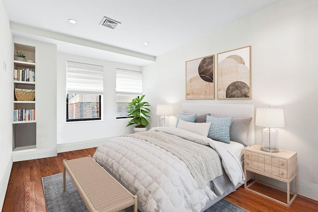 bedroom with dark wood-type flooring