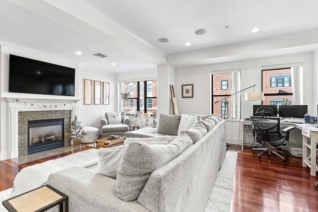 living room with a healthy amount of sunlight, a fireplace, and dark hardwood / wood-style flooring