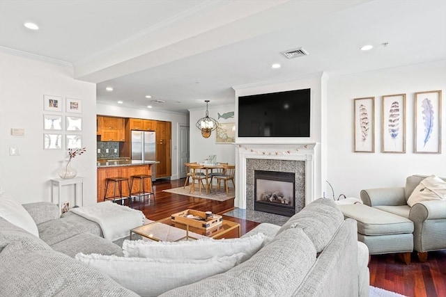 living room featuring ornamental molding and dark hardwood / wood-style floors