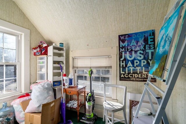 interior space featuring wallpapered walls and vaulted ceiling