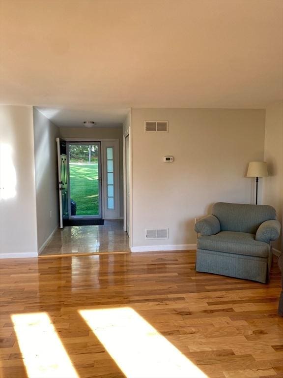 foyer featuring baseboards and wood finished floors