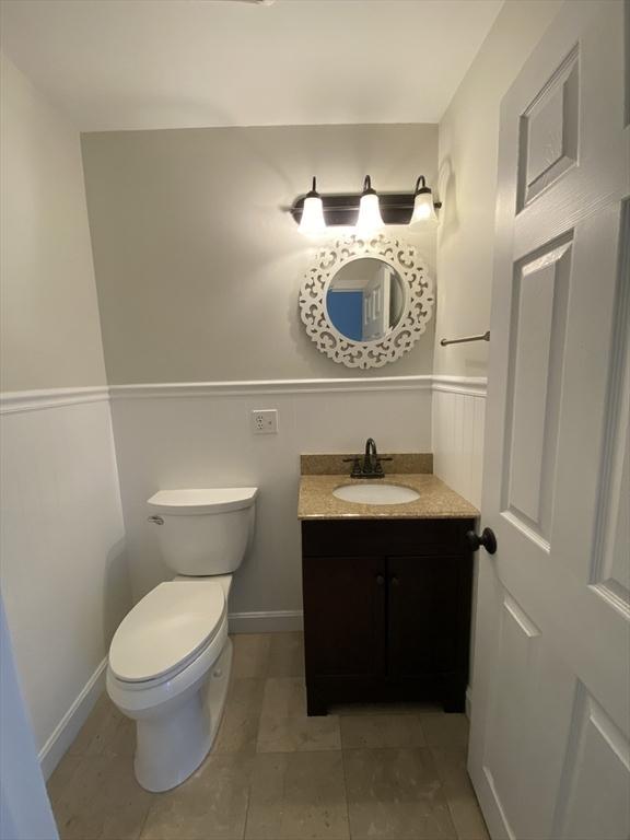 bathroom featuring toilet, vanity, baseboards, and tile patterned floors